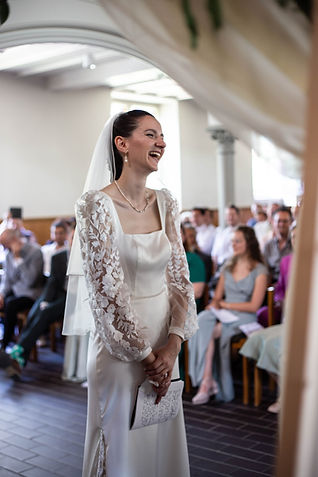 a bride laughing while the vows are being read at her wedding in central Zürich