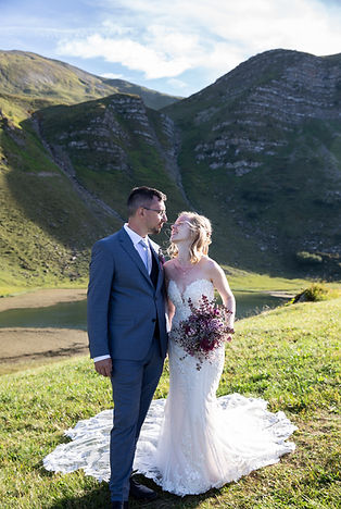 a bride and groom holding each other in a wedding photoshoot in the mountains 