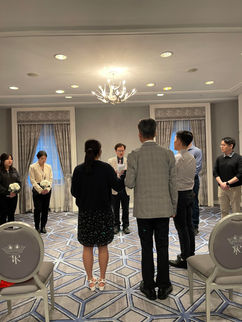 Small venue wedding rehearsal from middle of aisle view.