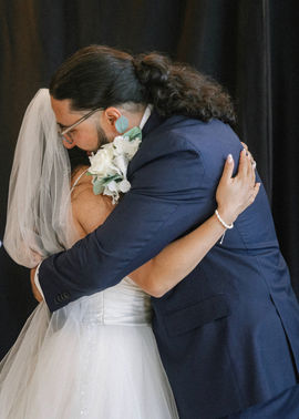 Bride & groom embracing in a hug.