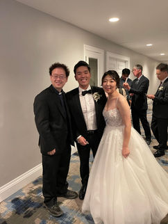 Pastor Paul posing for a photo with the bride & groom.