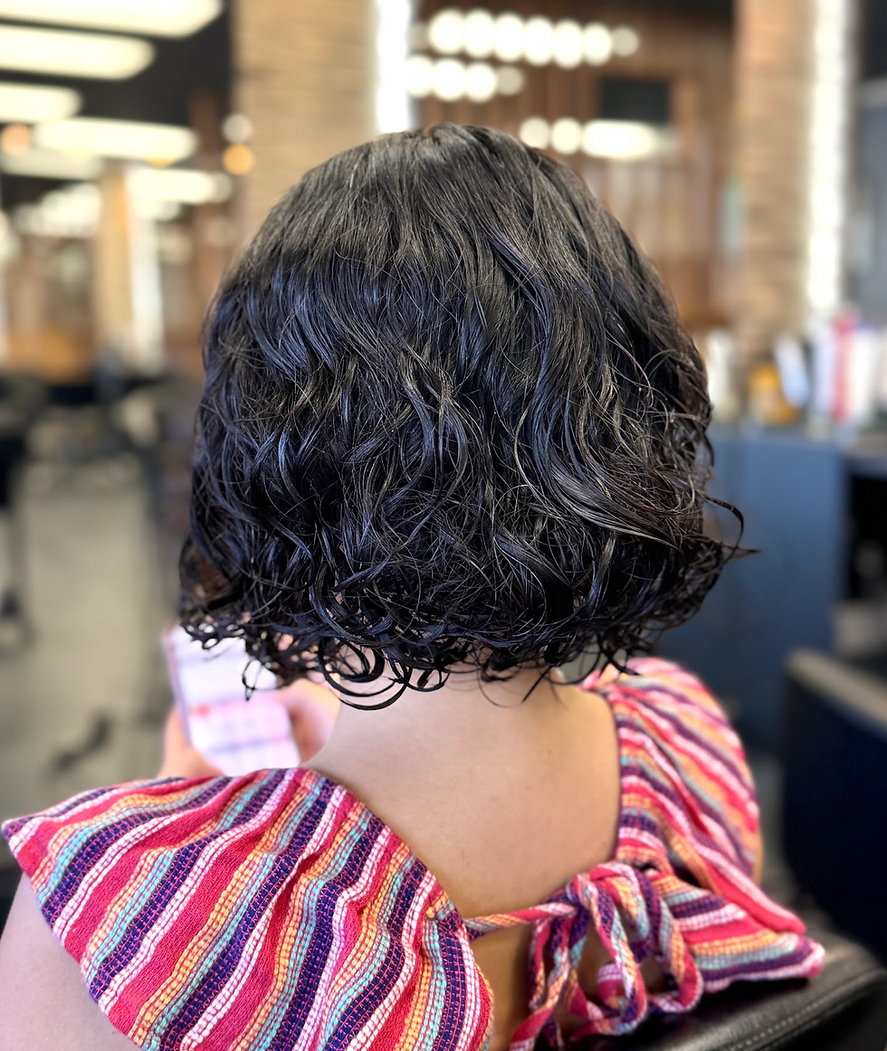 Short wavy hairstyle in a salon setting