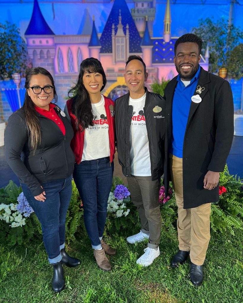 Allie and a group of Ambassadors in front of a castle backdrop
