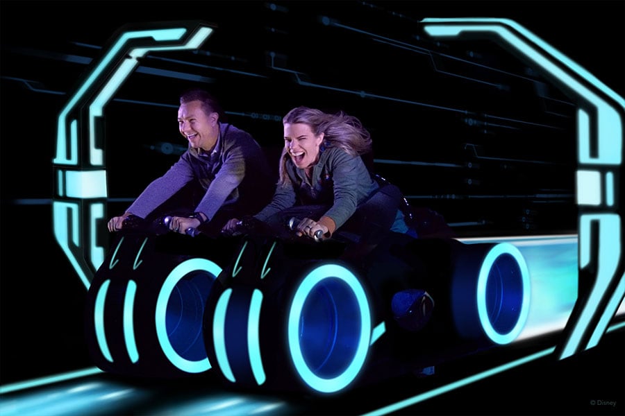 Guests smiling while riding TRON Lightcycle / Run presented by Enterprise
