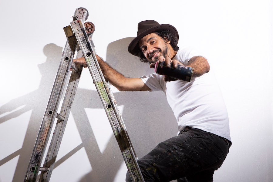 Disney Springs Art Walk artist on ladder