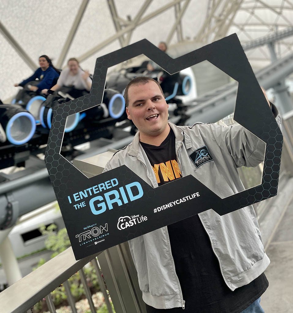 Cast member holds TRON frame that says 'I entered the grid'