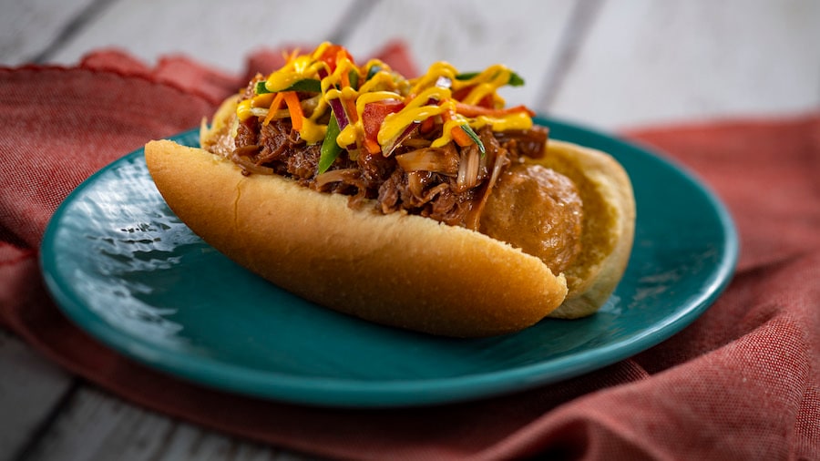 Plant-based Bratwurst with spicy turmeric aïoli, coffee barbecue jackfruit, and slaw