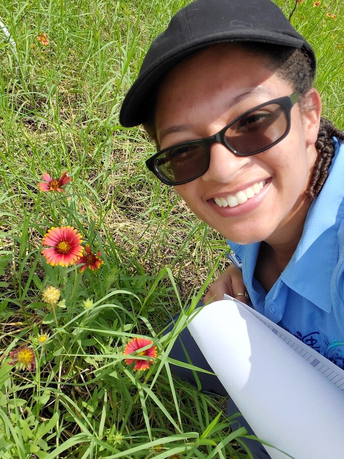 Cast member with wild flowers