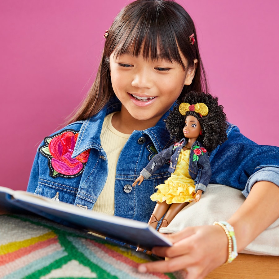 Girl playing with a Disney ily 4EVER doll