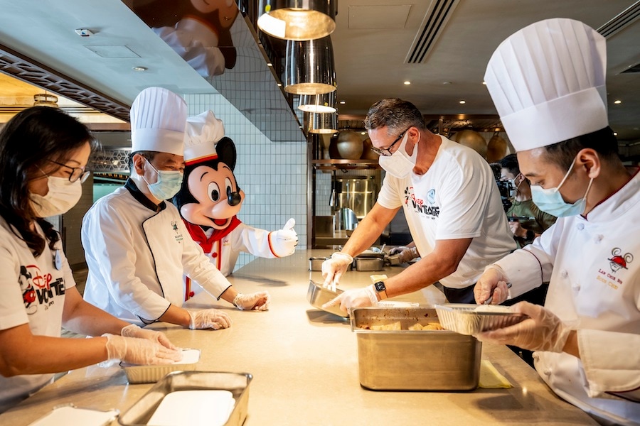 Cast members and VoluntEARS at Hong Kong Disneyland Resort prepare healthy cooked meals as part of the Disney Meal Box Express