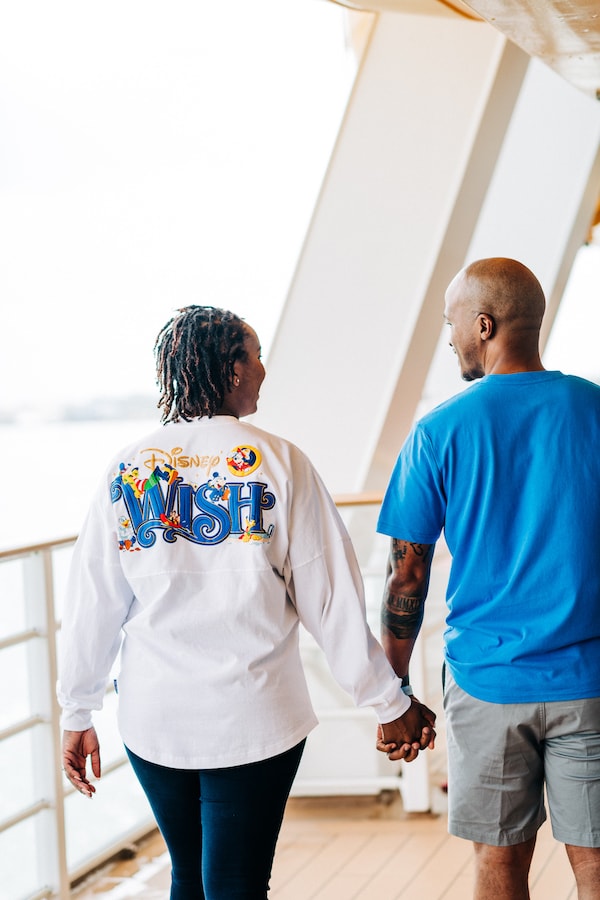 Families in various Disney Wish shirts