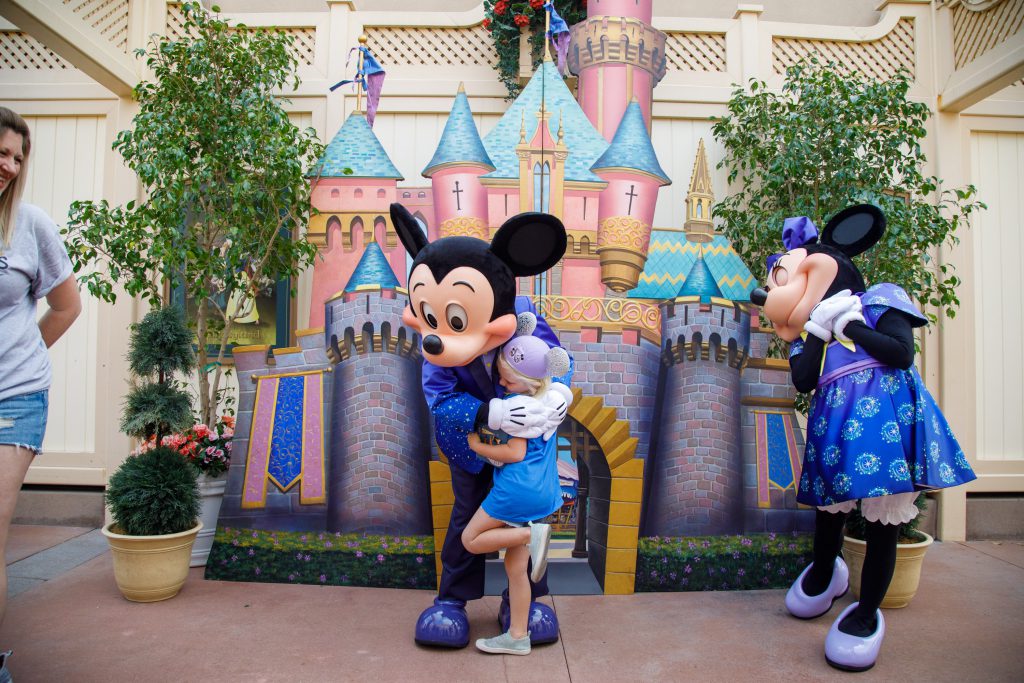 Mickey and Minnie Mouse share hugs with Make a Wish Family