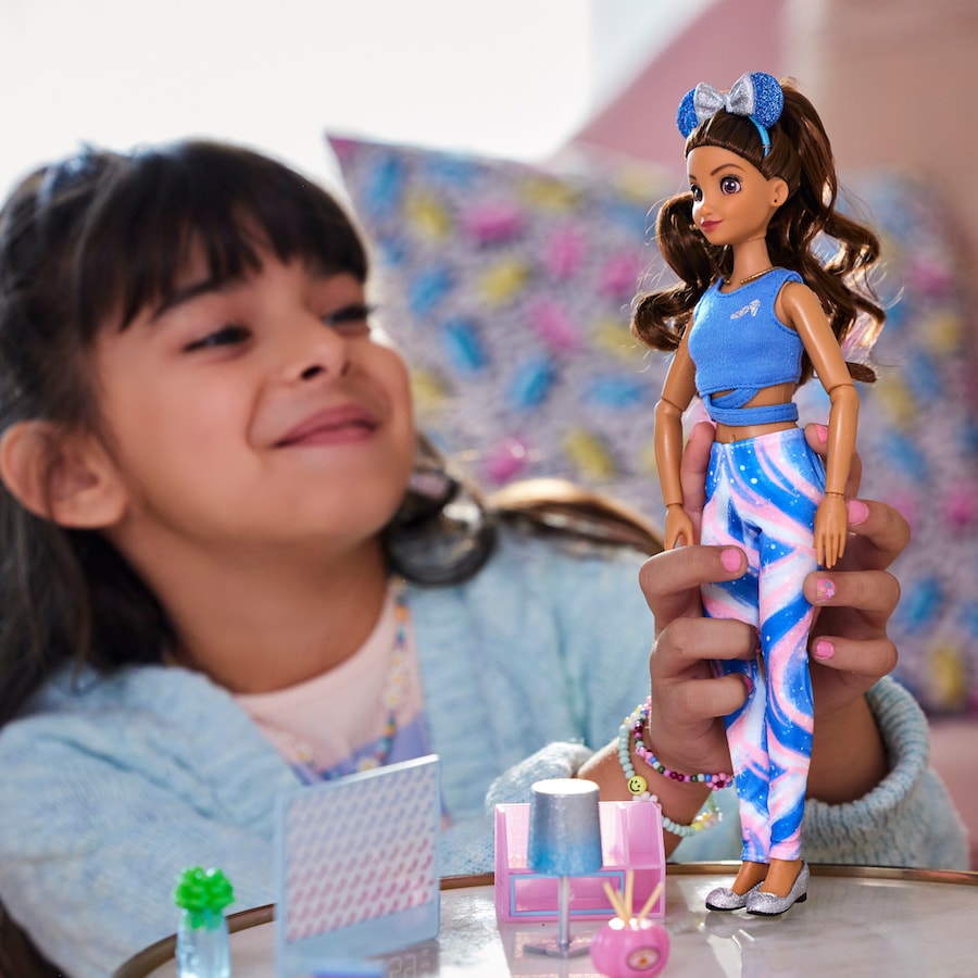 Girl playing with a Disney ily 4EVER doll