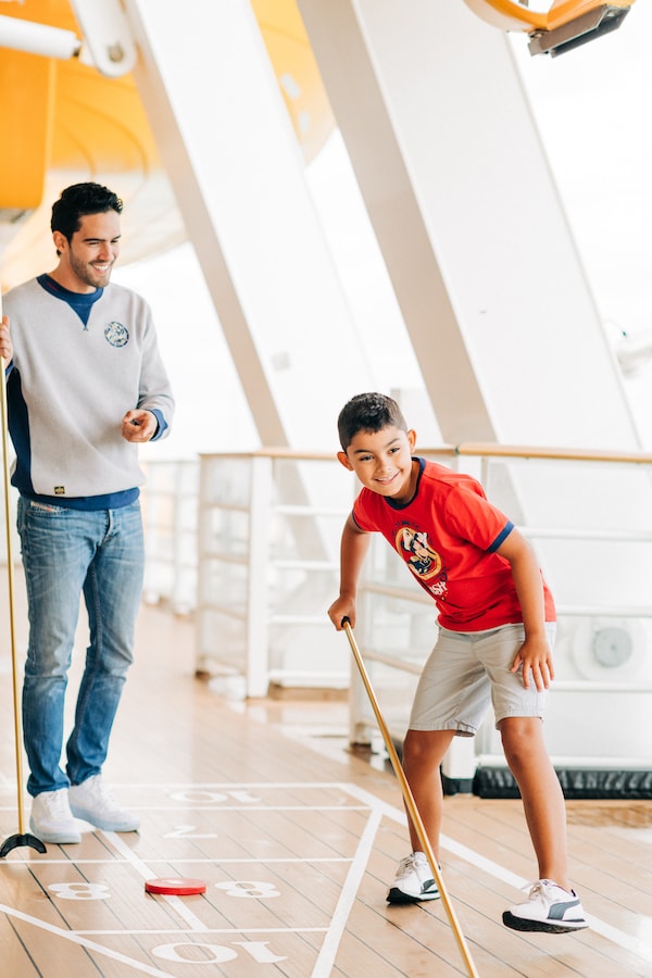 Families in various Disney Wish shirts