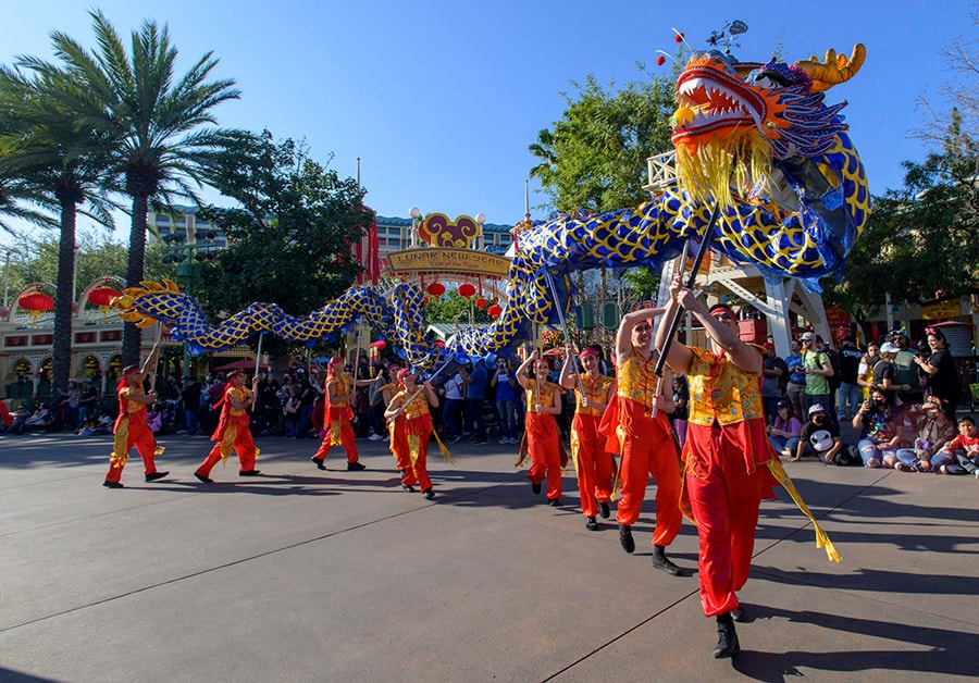perforers holding a dragon puppet during Mulan's Lunar New Year Proession at Disney California Adventure