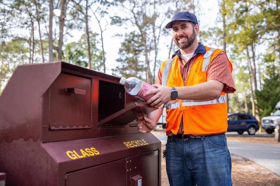 Cast member collecting recyclables