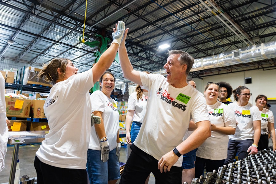 Several Cast Member VoluntEARS high five