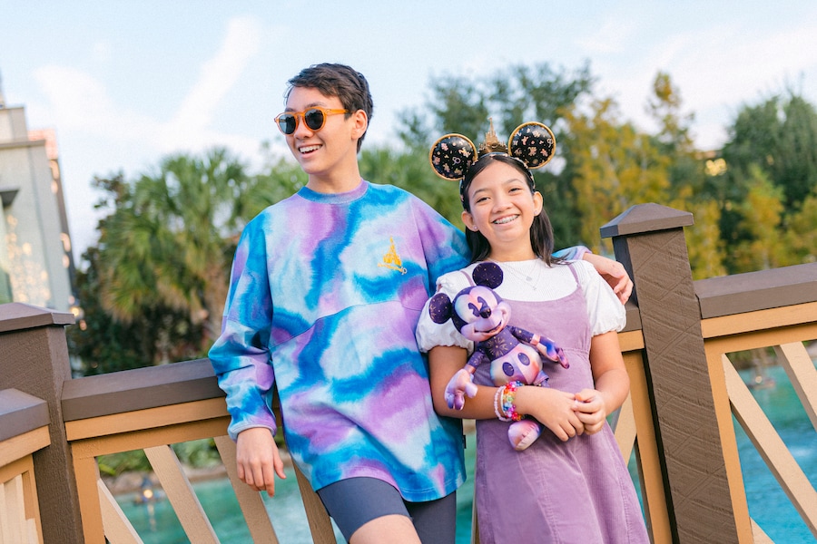 Guests wearing pieces from the Walt Disney World 50th Anniversary Grand Finale Collection