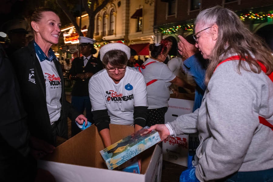 Disney VoluntEARS at Toys for Tots Drive at Disneyland Resort with plastic-free packed Merida classic doll