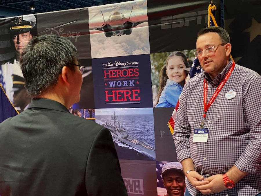Disney cast member Gordon Campbell chats with an attendee of the 2023 Student Veterans of America National Conference at Walt Disney World Resort
