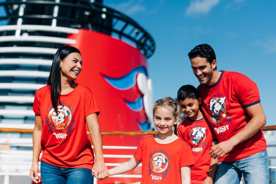 Families in various Disney Wish shirts