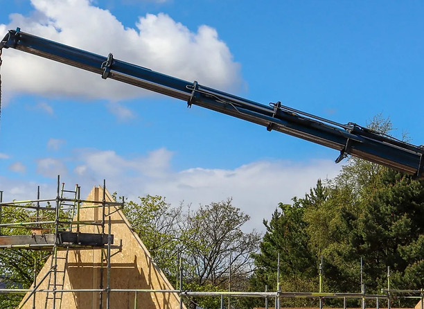Crane lifting the roof off a build RIC worked on