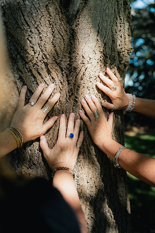 Group gathering with hands joined together during a connection-focused retreat experience