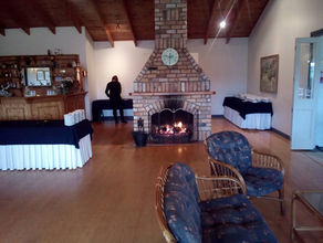 Cosy fireplace and lounge area inside the Lake Hill Estate hall, ideal for weddings and private events