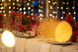 wedding decoration photoghraphy, outdoors wedding setup with seaview at sunset and golden hour with fairylights