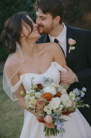 Bride and groom holding a bouquet of flowers