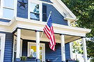 blue-house-white-trim-american-flag.jpg
