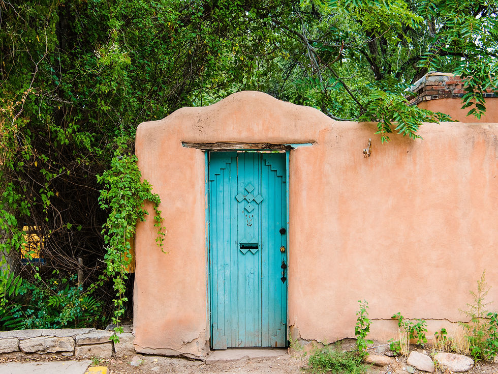Wood turquoise colored door set in an old adobe wall in Santa Fe, New Mexico.jpg