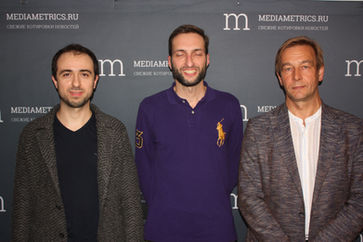 Loran Jacobs, Vladimir Konyshev, and the broadcast presenter standing inside a modern recording studio.