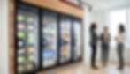 Three professional women in an Atlanta tech office standing in front of AI-powered smart coolers featuring modern, cashless snack and beverage options.