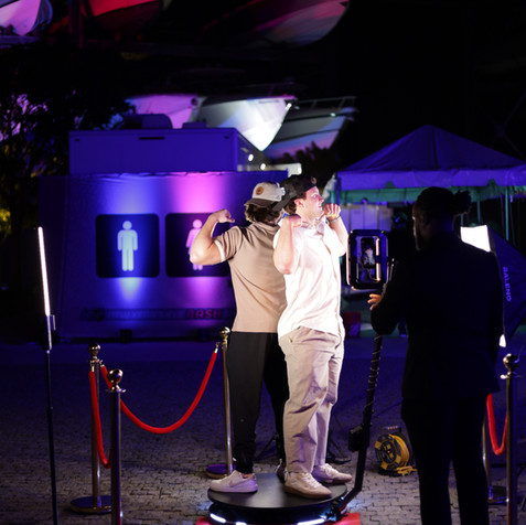 Premium 360 photo booth rental with red velvet ropes at a high-energy Miami Beach nightlife event.