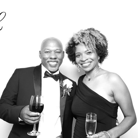 Premium black and white photo booth rental with custom monogram overlay for luxury weddings.