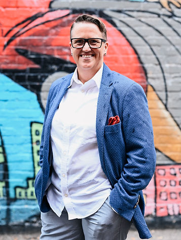 Emily standing in front of graffiti smiling