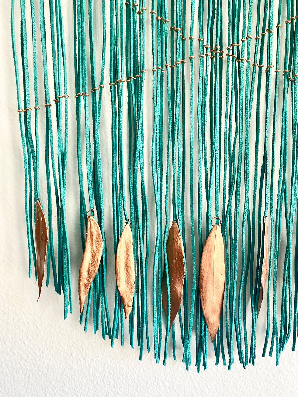 Thumbnail: Leather wall hanging with copper leafs and lemurian quartz