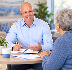 Shannon Redman discussing Medicare options with a client in a relaxed, educational setting.