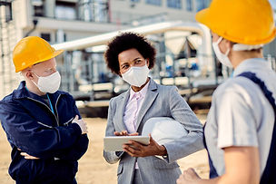 african-american-building-contractor-talking-civil-engineers-construction-site-coronavirus