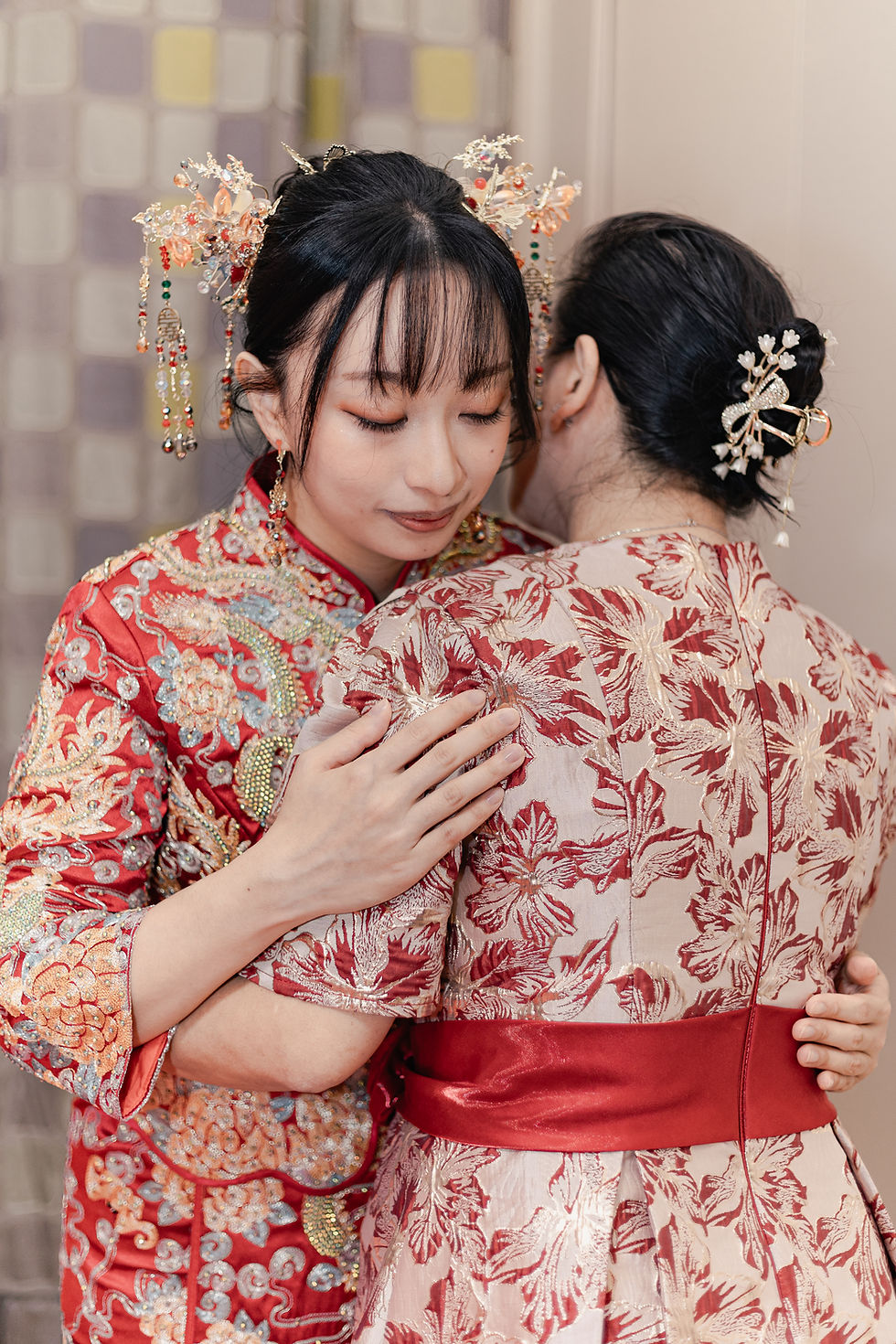 This is a Chinese style tea ceremonies where the bride mother is help the bride to wearing the wedding dress