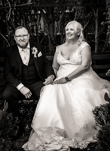 Midlands bride and groom posed sitting at the Hundred House, Shropshire.