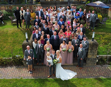 Group photo of wedding guests by drone photographer in the Midlands.