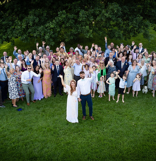 Dynamic drone photo of wedding guests.
