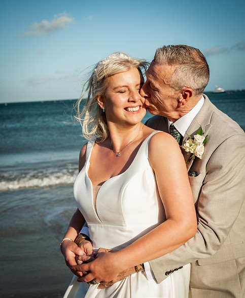 Dudley wedding photographer with couple at Swanage beach.