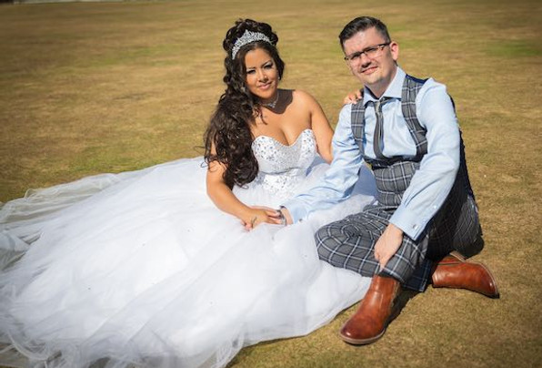 Bride and Groom Photo sat on the lawn.