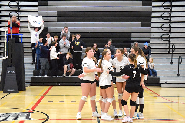 The North Star Wolves junior girls volleyball team celebrates their match-winning point against Leamington Dec. 16.