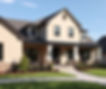 A stucco home with neutral colors, a dark roof, big porch, and show the entire home.jpg