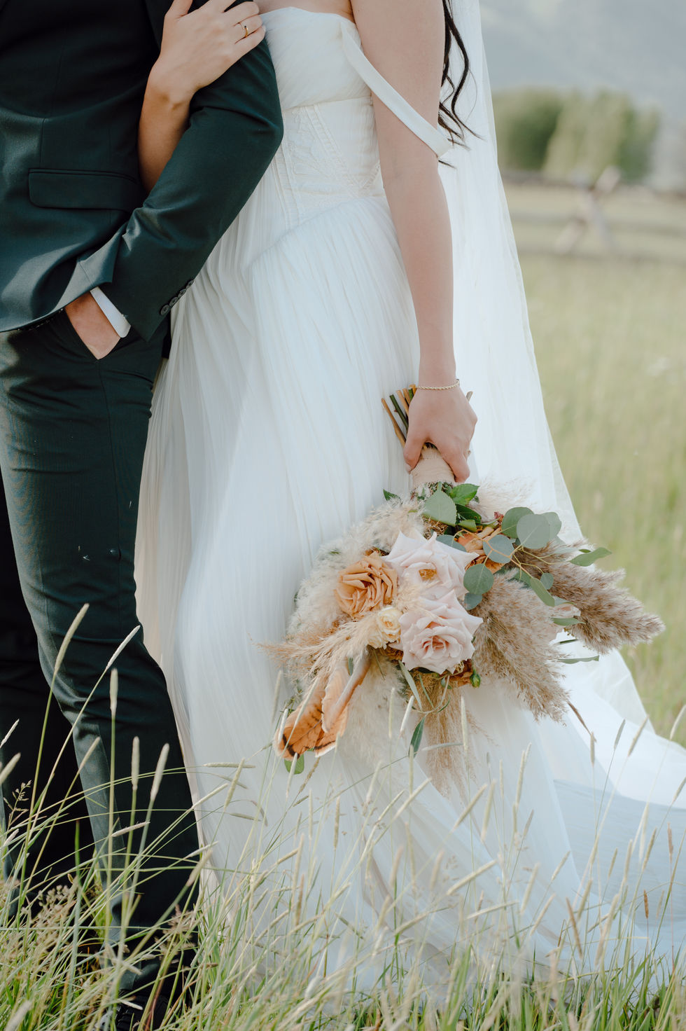 Couple Portrait with Boho bridal bouquet near Grand Tetons Mountains in Jackson Hole Wyoming