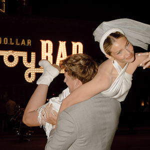 Bride over Groom's Shoulder outside of Cowboy Bar Jackson Hole Wyoming